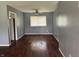 Open living room with hardwood floors, ceiling fan, and window providing natural light at 2346 Mayfair Dr, Indianapolis, IN 46260