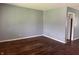 Corner view of living room showing light gray walls and original hardwood flooring at 2346 Mayfair Dr, Indianapolis, IN 46260