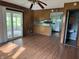 Open living room flows into kitchen; features wood-paneled walls, laminate floors, and access to a sunroom at 2346 Mayfair Dr, Indianapolis, IN 46260
