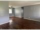 Spacious living room featuring hardwood floors, neutral-colored walls, and a ceiling fan at 2346 Mayfair Dr, Indianapolis, IN 46260