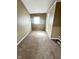Cozy bedroom with neutral-toned walls and carpet, featuring a window and a door at 2523 S Mcclure St, Indianapolis, IN 46241