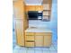 Kitchen features ample cabinet space and countertops, microwave, and tiled floors at 2523 S Mcclure St, Indianapolis, IN 46241