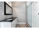 Elegant bathroom featuring a double sink vanity, granite countertop, and glass shower at 2528 Guilford Ave, Indianapolis, IN 46205