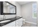 Stylish bathroom with double vanity, granite counters, tile floors, and great natural light at 2528 Guilford Ave, Indianapolis, IN 46205