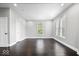 Neutral bedroom with hardwood floors, large windows, and white trim at 2528 Guilford Ave, Indianapolis, IN 46205