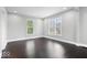 Bright and airy bedroom featuring hardwood floors and two large windows at 2528 Guilford Ave, Indianapolis, IN 46205