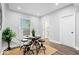 Cozy dining area featuring modern seating, natural light, and view of the staircase at 2528 Guilford Ave, Indianapolis, IN 46205