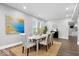 Dining area with modern table and chairs and a decorative mirror, offering natural light at 2528 Guilford Ave, Indianapolis, IN 46205