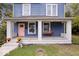 Close up of a blue home's front porch with swing, white pillars, and a peach-colored door at 2528 Guilford Ave, Indianapolis, IN 46205