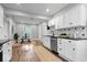 Open-concept kitchen featuring modern appliances, white cabinetry, and a breakfast nook with a decorative backsplash at 2528 Guilford Ave, Indianapolis, IN 46205