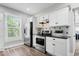 Kitchen with stainless steel appliances, white cabinetry, and granite countertops at 2528 Guilford Ave, Indianapolis, IN 46205