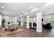 Open-concept living and dining area with hardwood floors, white columns, and modern decor at 2528 Guilford Ave, Indianapolis, IN 46205