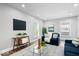 Inviting living room with modern decor, a flat-screen TV, and an abundance of natural light at 2528 Guilford Ave, Indianapolis, IN 46205