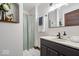 Bathroom with a vanity, mirror, white and black tile flooring, and shower with curtain at 2532 Madison Ave, Indianapolis, IN 46225