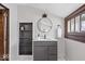Bright bathroom featuring a vanity, mirror, shelves, and natural light from the window at 2532 Madison Ave, Indianapolis, IN 46225