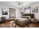 This bedroom has hardwood floors, a ceiling fan, and large windows, offering comfort and relaxation at 2532 Madison Ave, Indianapolis, IN 46225