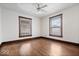 Bright bedroom with hardwood floors and a ceiling fan, ready for your personal style at 2532 Madison Ave, Indianapolis, IN 46225