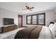 Comfortable bedroom featuring a ceiling fan, large windows, neutral paint, and stylish decor at 2532 Madison Ave, Indianapolis, IN 46225
