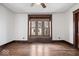 Bright bedroom with hardwood floors, a cozy window seat, and neutral walls, creating a relaxing space at 2532 Madison Ave, Indianapolis, IN 46225