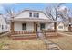 Charming two-story home featuring a covered front porch with brick pillars, offering a cozy curb appeal at 2532 Madison Ave, Indianapolis, IN 46225