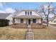 Charming two-story home featuring a covered front porch with brick pillars, offering a cozy curb appeal at 2532 Madison Ave, Indianapolis, IN 46225