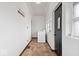Hallway with washer and dryer, tile flooring, coat rack, black door and natural light at 2532 Madison Ave, Indianapolis, IN 46225