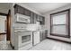 Functional kitchen with updated cabinets, appliances, and tile floors offers a practical cooking space at 2532 Madison Ave, Indianapolis, IN 46225