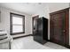 Spacious kitchen with a refrigerator, a window, and a wooden door is ready for your updates at 2532 Madison Ave, Indianapolis, IN 46225