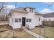 A charming home featuring white siding, a dark front door, and a fenced yard at 2532 Madison Ave, Indianapolis, IN 46225