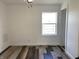 Cozy bedroom with wood floors, a ceiling fan and a window allowing natural light into the room at 2712 S A St, Elwood, IN 46036