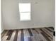 Bright bedroom featuring durable wood floors, a ceiling fan and a window with white trim at 2712 S A St, Elwood, IN 46036
