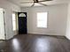 Open living area with a fan and modern dark flooring with entry to front door and lots of natural light at 2712 S A St, Elwood, IN 46036