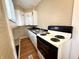 Functional kitchen equipped with white appliances, a stainless steel sink, and ample counter space at 2821 E 13Th St, Indianapolis, IN 46201