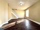 Inviting living room with original hardwood floors, staircase, and natural light streaming through the window at 2821 E 13Th St, Indianapolis, IN 46201