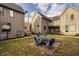 Backyard with firepit and outdoor seating, surrounded by well-maintained lawns at 304 E 17Th St, Indianapolis, IN 46202