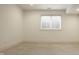 Spacious finished basement with neutral carpet, recessed lighting, and a bright window at 304 E 17Th St, Indianapolis, IN 46202