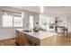 Kitchen island with stainless steel appliances and view into the living room featuring a fireplace at 304 E 17Th St, Indianapolis, IN 46202