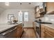 Well-lit kitchen showcasing stainless steel appliances, wood cabinets, and a view through the window at 304 E 17Th St, Indianapolis, IN 46202