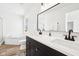 Bright bathroom featuring double sinks, a tub, and natural light from a window at 3155 N White River Pkwy E Dr, Indianapolis, IN 46208