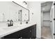Bathroom showcasing double sinks, modern fixtures, and a view into the walk-in closet at 3155 N White River Pkwy E Dr, Indianapolis, IN 46208