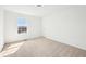 Bright, minimalist bedroom featuring neutral carpet and natural light at 3155 N White River Pkwy E Dr, Indianapolis, IN 46208