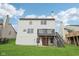 Rear exterior view showcases the home's deck and yard, perfect for outdoor living and entertaining at 3155 N White River Pkwy E Dr, Indianapolis, IN 46208