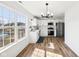Modern kitchen featuring stainless steel appliances, a view of the backyard, and island sink at 3155 N White River Pkwy E Dr, Indianapolis, IN 46208