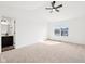 Spacious bedroom with a ceiling fan, large window, and attached bathroom at 3155 N White River Pkwy E Dr, Indianapolis, IN 46208