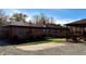 The backyard features a grassy lawn, small patio, detached garage, and a brick home at 316 Elm St, Greenwood, IN 46142