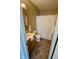 Bathroom with wood vanity, toilet, shower, and light walls, featuring tile flooring at 316 Elm St, Greenwood, IN 46142