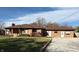 A brick home with a large front yard, gravel driveway, and brown roof at 316 Elm St, Greenwood, IN 46142