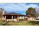 Charming brick home featuring a well-maintained lawn and mature trees at 316 Elm St, Greenwood, IN 46142
