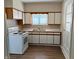 A kitchen featuring white cabinets, wood trim, a white stove, and dark wood flooring at 316 Elm St, Greenwood, IN 46142
