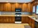 Traditional kitchen with wooden cabinets, laminate countertops, and updated appliances at 316 Elm St, Greenwood, IN 46142